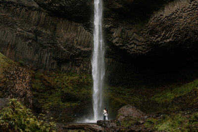 Couple share a kiss at the base of Latourell Falls.