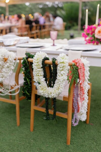 Leis hanging of the back of a chair 