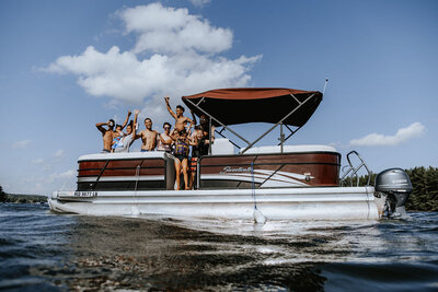 A family hangs out on a boat on the lake.