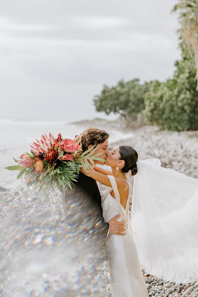 Maui bride and groom share a kiss at the Olowalu Plantation House