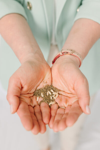 Lindsay holing seeds in the palm of her hands