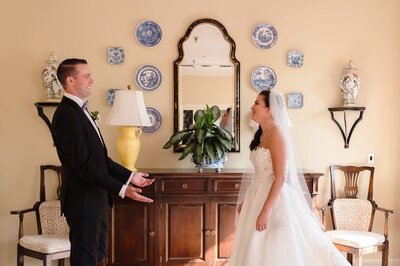 Bride and groom's first look in front of a mirror at the Skokie Country Club in Glencoe, IL