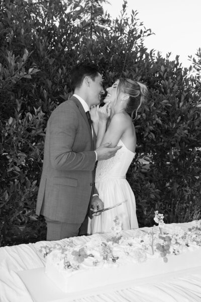 Wedding Photography, black and white of bride and groom laughing together at reception