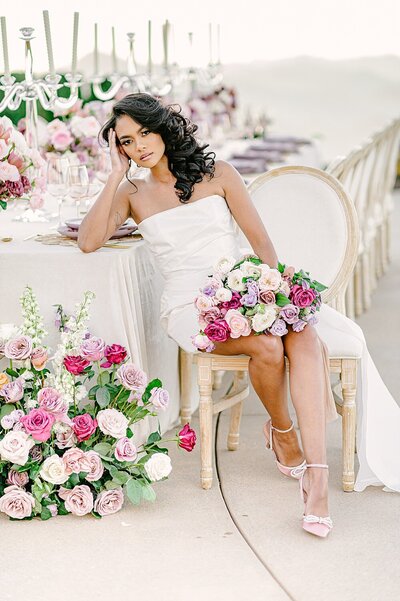 Melissa Williams, a luxury wedding planner, poses in a pink suit.