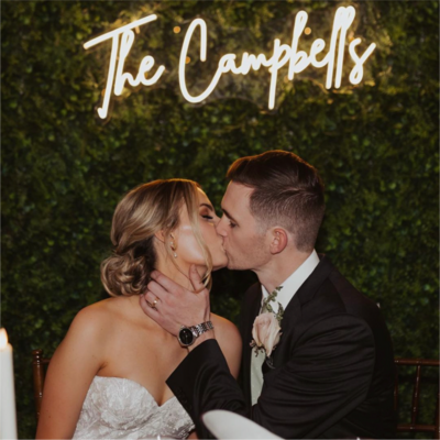 a large love sign in front of the sweetheart table