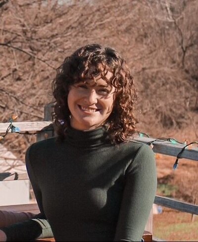 Headshot of a woman in a pink dress