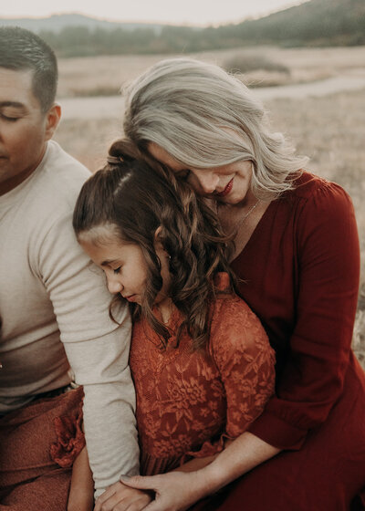 Mom prays over her young daughter at Dawsons Butte