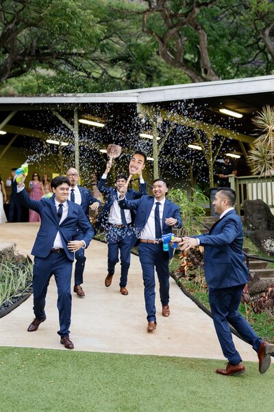 A wedding party dancing and celebrating as they shoot bubbles together 