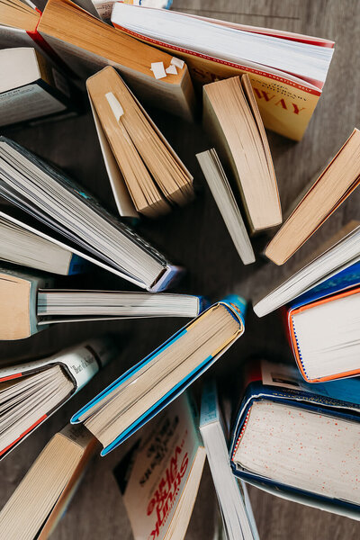 Close-up of books arranged on a table, symbolizing creativity and inspiration.