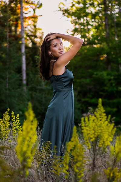 Graduating Senior with hands on head and sun in back | Senior Photo Session