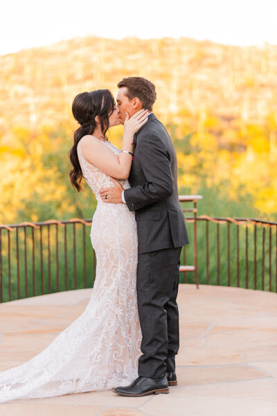 couple kissing during wedding ceremony