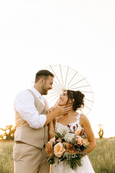 bride and groom portrait with a  umbrella