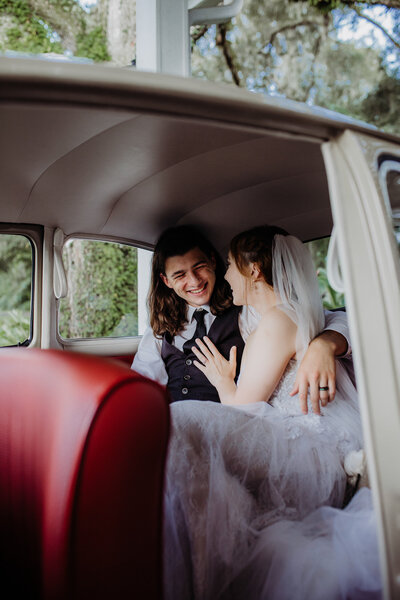 Couple in vintage car wedding portraits