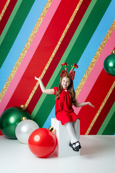 Child exploring a whimsical Christmas Toy Shop set during a festive holiday photo session in Canton, Georgia