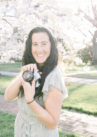 jacqueline burns holding camera in the spring