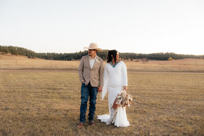 Tiernee and Nick holding hands at their Hermosa, South Dakota wedding.