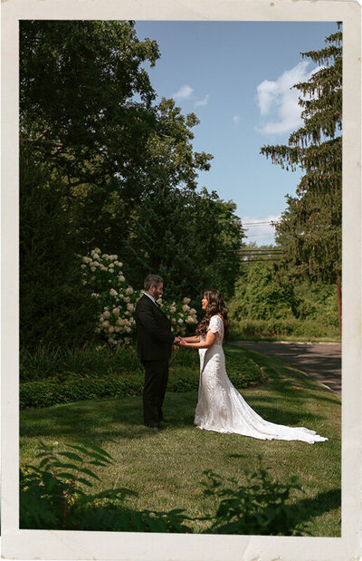 Outdoor photo of a bride and groom neat greenery at a luxury wedding in New York