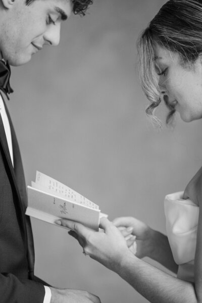 bride reading vows to husband during first look taken by wedding photographer in Orlando, Blak Marie