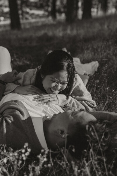 mount laguna engagement, girl smiling at guy, laying in grass