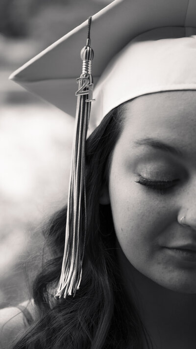Black and white close up photo of a graduating high school girl