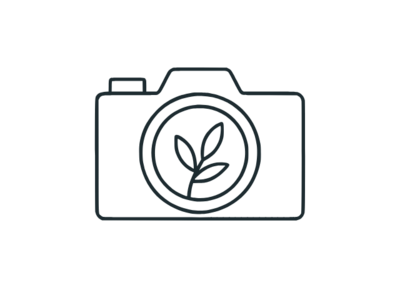 Outline icon of a camera, representing professional photography services for websites.