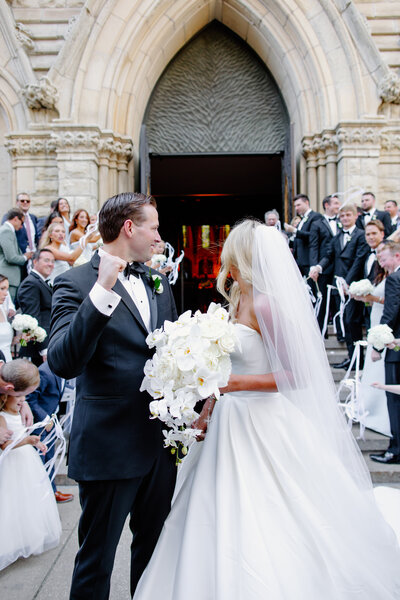 Bride and groom walk down Chicago church steps after getting married