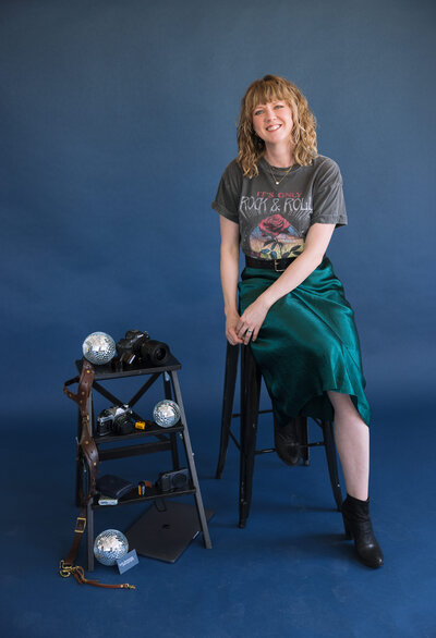 leah thomason smiling with cameras and gear