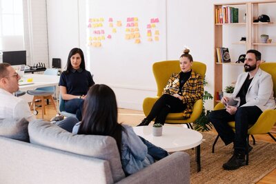 Group of therapists sitting in chairs in a circle