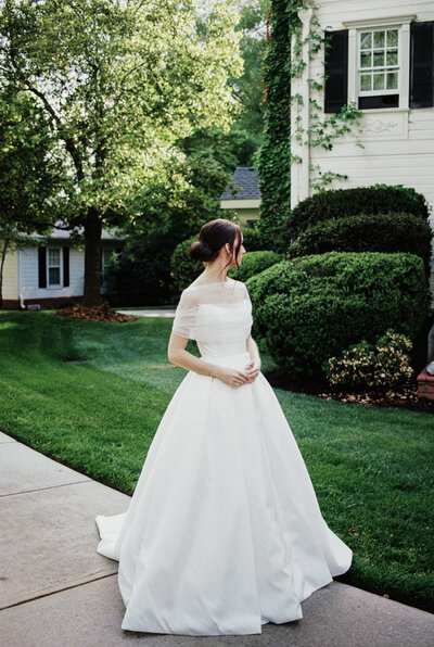 A film capture of a bride looking back over her shoulder while at The Grand Holland wedding venue.