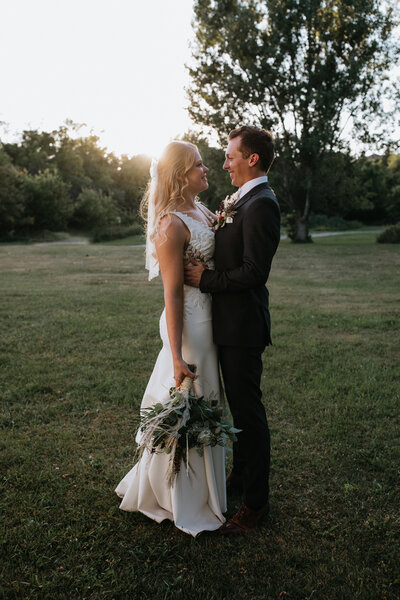 bride and groom facing each other at sunset taken by fargo wedding photographer kiella lawrence