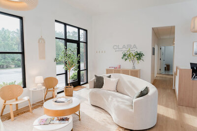 White couch and modern furniture sit inside the interior lobby of Clara Dermatology business in Raleigh NC | Sara Coffin Photo