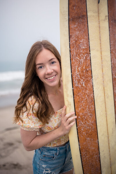 photographer holding surfboard