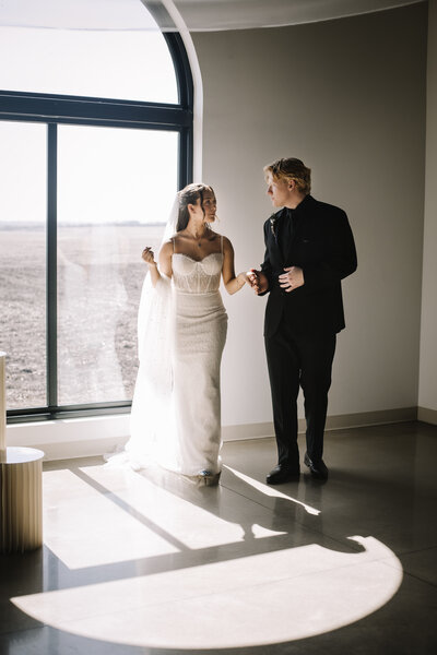 Bride and groom holding hands