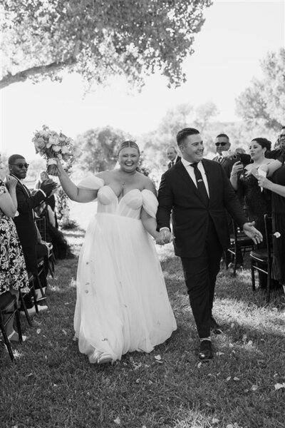 Andrea Cakmar and her husband walk down the aisle on their wedding day.