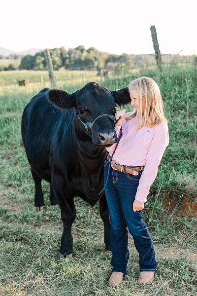 Adorable photos of a child and her cow on a farm, capturing their bond and the rural charm of the countryside