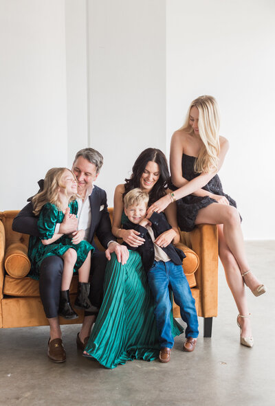 Family with toddler sitting in leaves in Denver