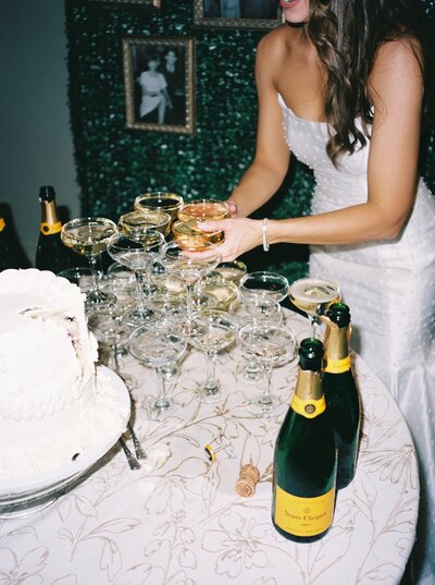 film photo of bride at champagne tower at the corinthian