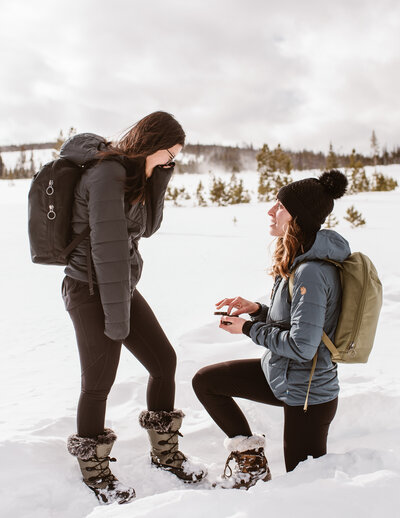 Couple playfully holds hands and runs down the street during their engagement session with Colorado engagement and couples photographer Avenir Photo Co.