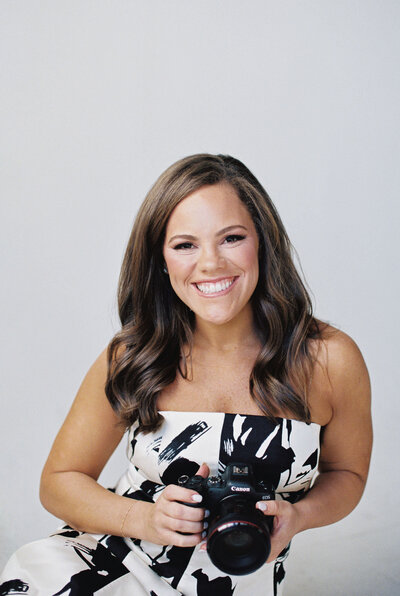 Claire Hodges smiling with her camera