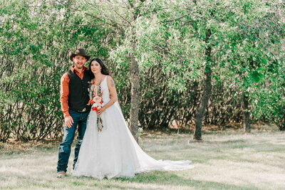 Bride holding husband's arm on a walking path at the U of S.