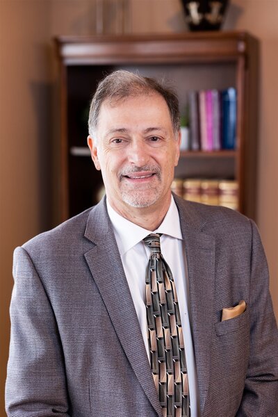 Headshot of Michael Luchetta posing in front of family law books