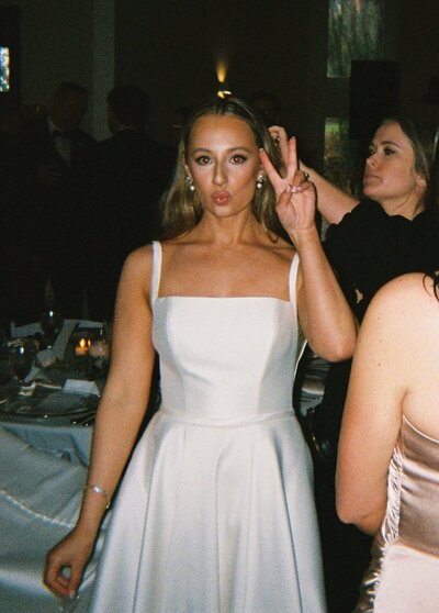 Flash photo of bride holding up a peace sign
