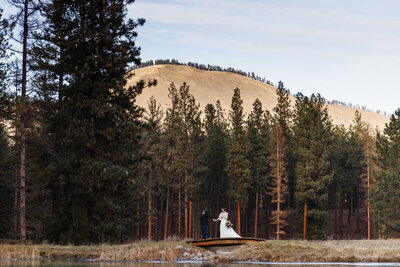 couple walking through trees taken by Minnesota wedding photographer Marcus Hanenburg Photography