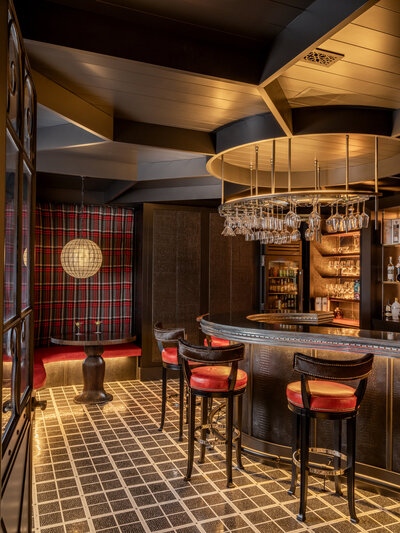 Dark and moody bar with red and plaid accents 