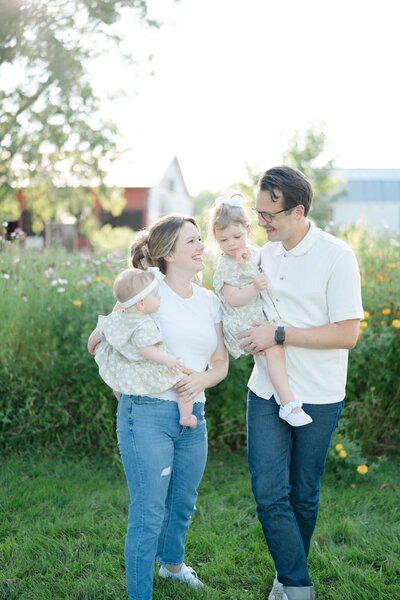 A-family-of-four-are-taking-their-family-photos-in-a-wildflower-filed-outside-of-nashville-with-nashville-family-photographer-dolly-delong