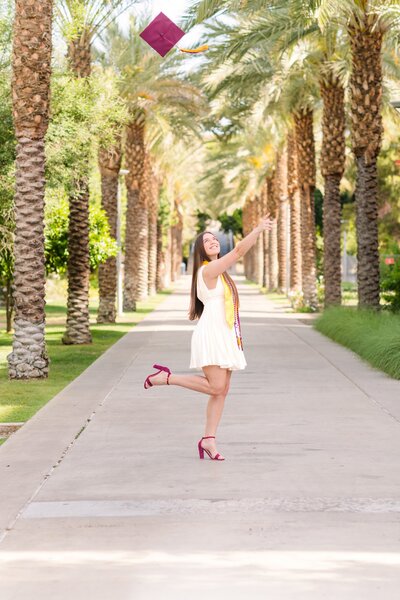 Arizona State University graduate posing for senior photos at palm walk in tempe az