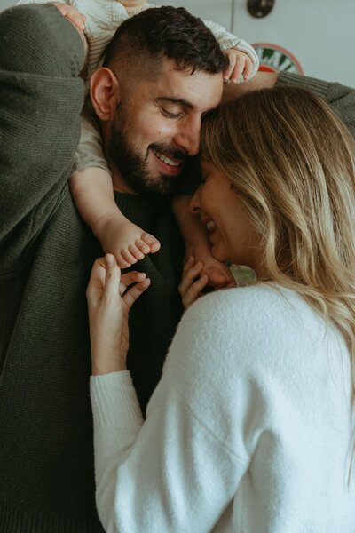 couple holding their son during family photos captured by NYC family photographer Elsie Goodman