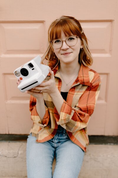 Tiffany smiles with her camera
