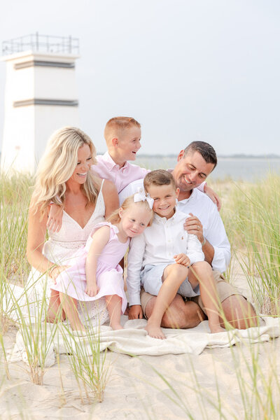 family portraits with a lighthouse and tall grass
