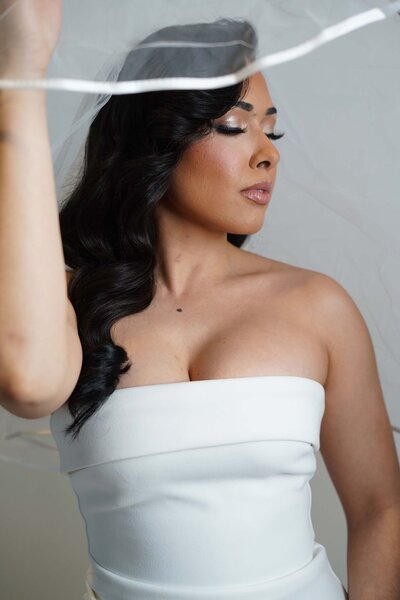 Bridal Makeup Artist in NYC creates a flawless wedding day look for a bride in a white dress – Skinlux Beauty Bar, serving NYC, NJ & PA.